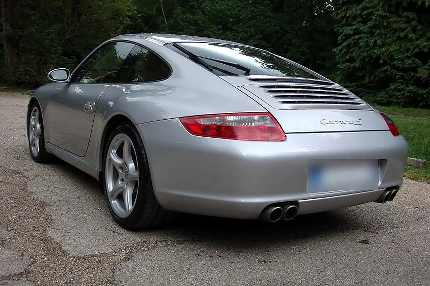 Porsche 911 Carrera S 997 gris argent de trois quarts arrière, logo Carrera S et quatre sorties d'échappement
